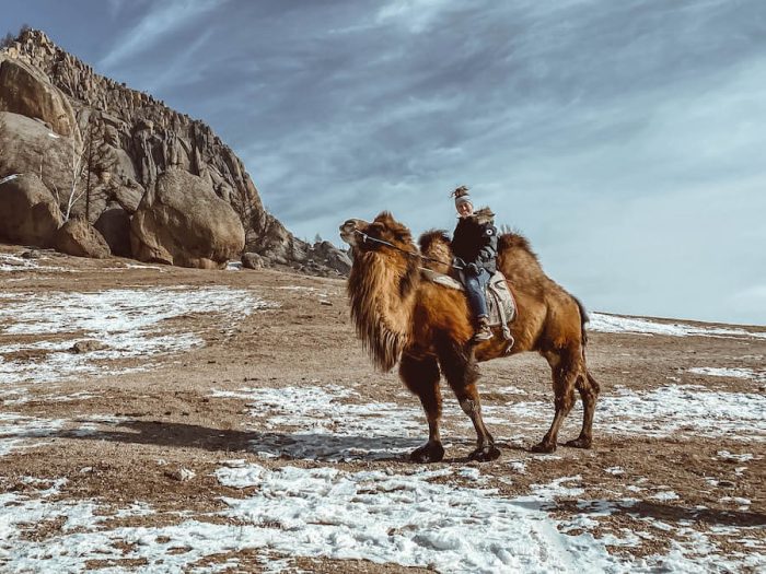 Breanna Wilson riding a camel in Mongolia