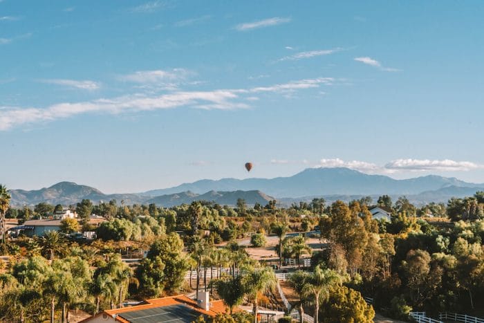 Landscape over Temecula Valley with hot air balloon in distance